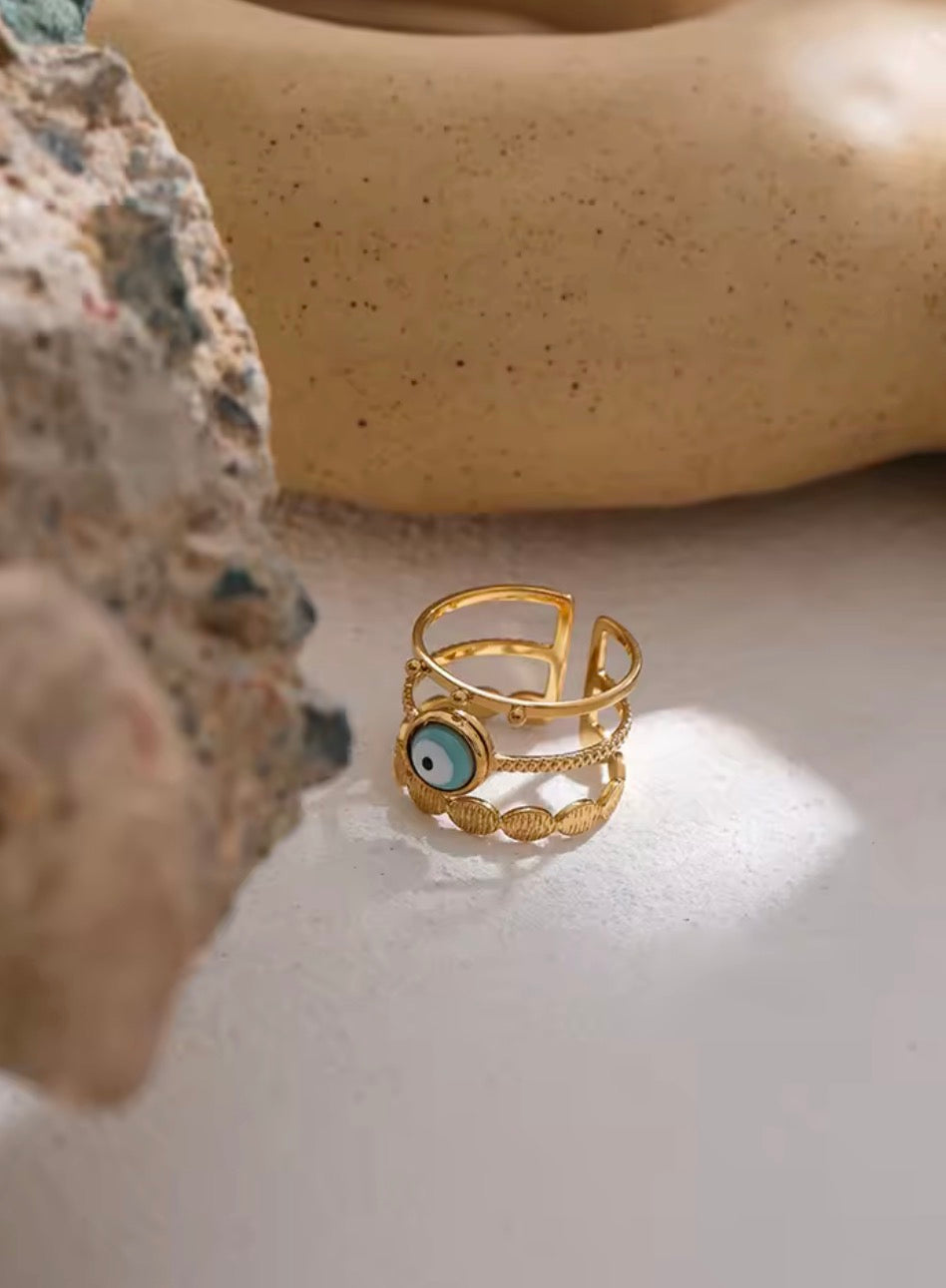 Evil Eye 3-Layer Ring flat lay on marble surface — 18K gold plated adjustable ring with turquoise evil eye stone